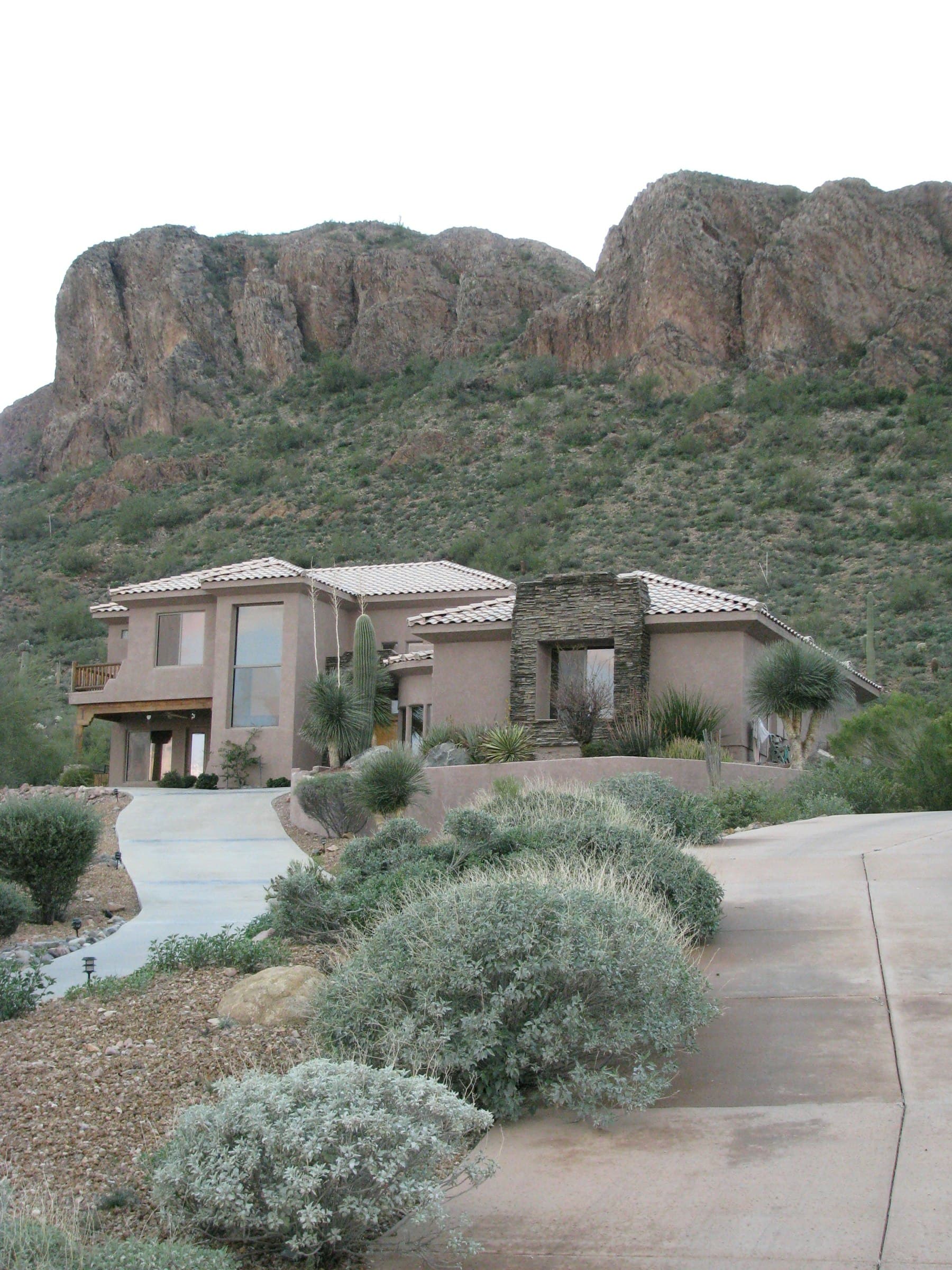 Stucco home in front of red rock cliffs in Southern Utah